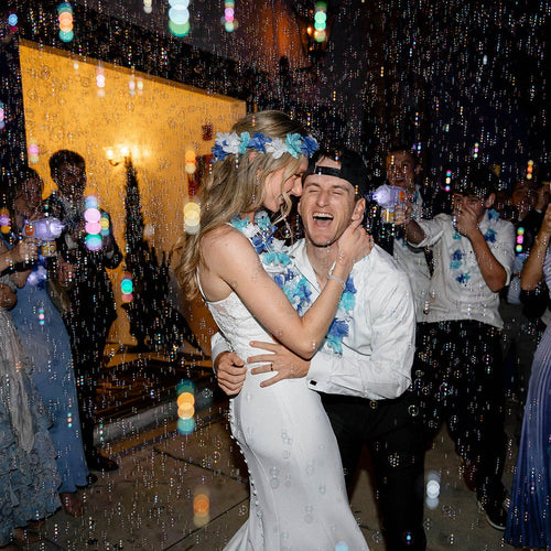 Wedding guests celebrating on a packed dance floor with DJ Nugget